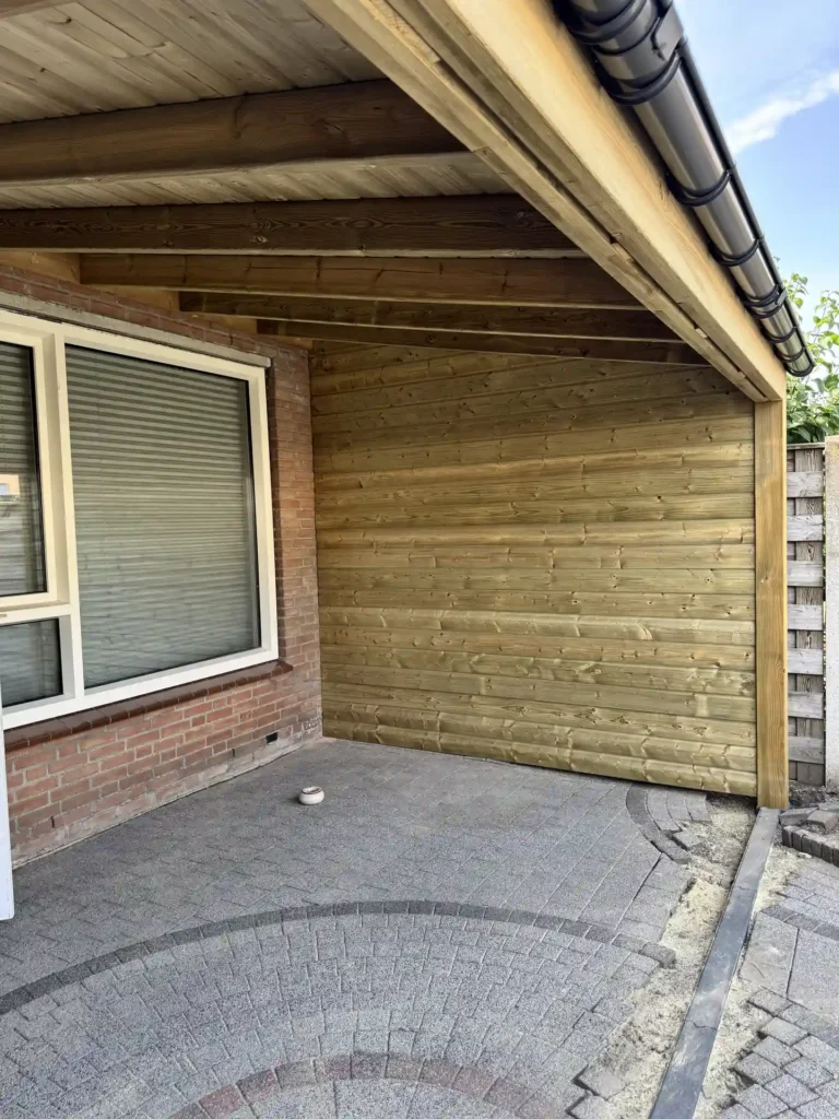 Houten overkapping met houten dakconstructie tegen een woning in de tuin